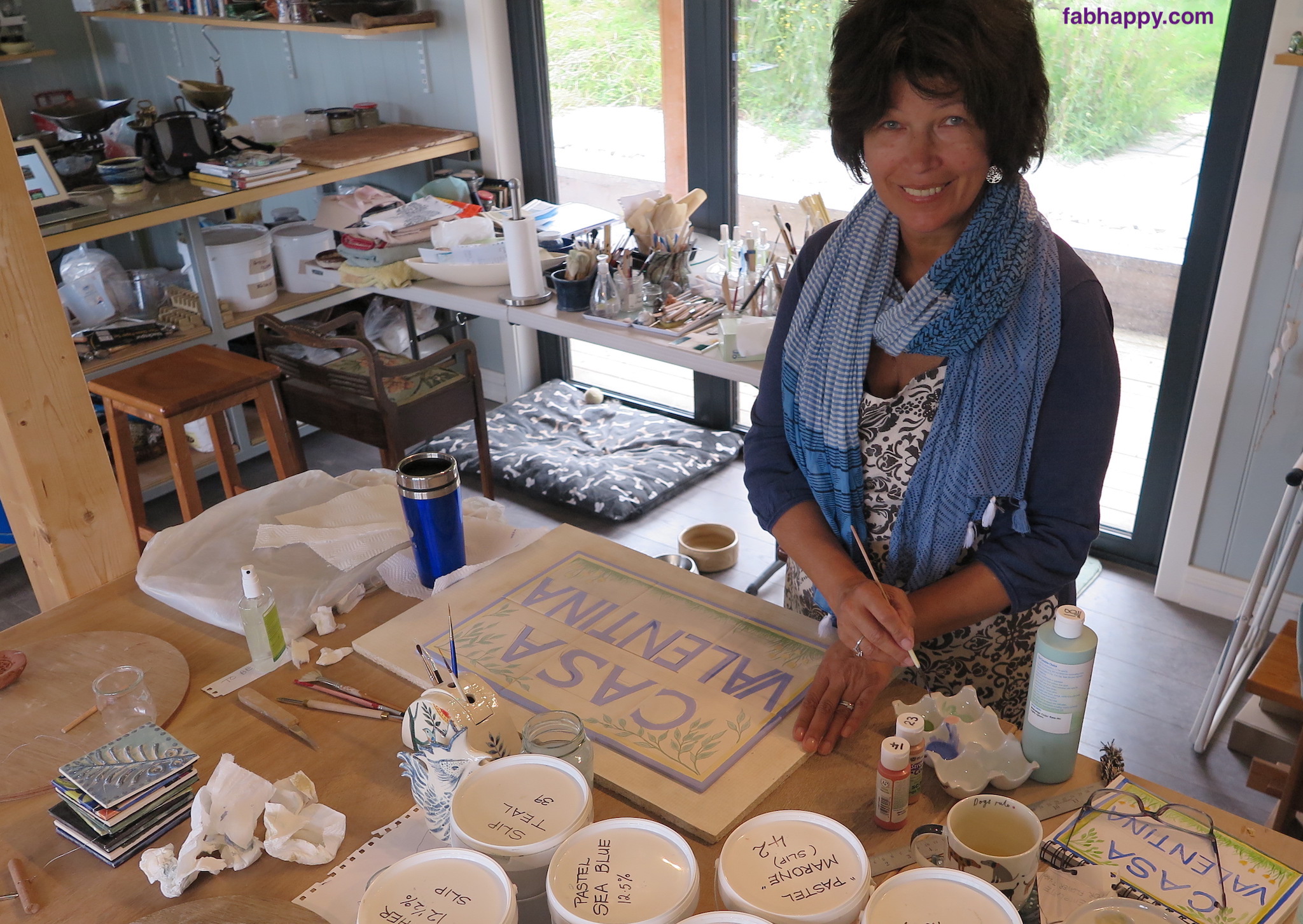Gloria painting the ceramic house sign